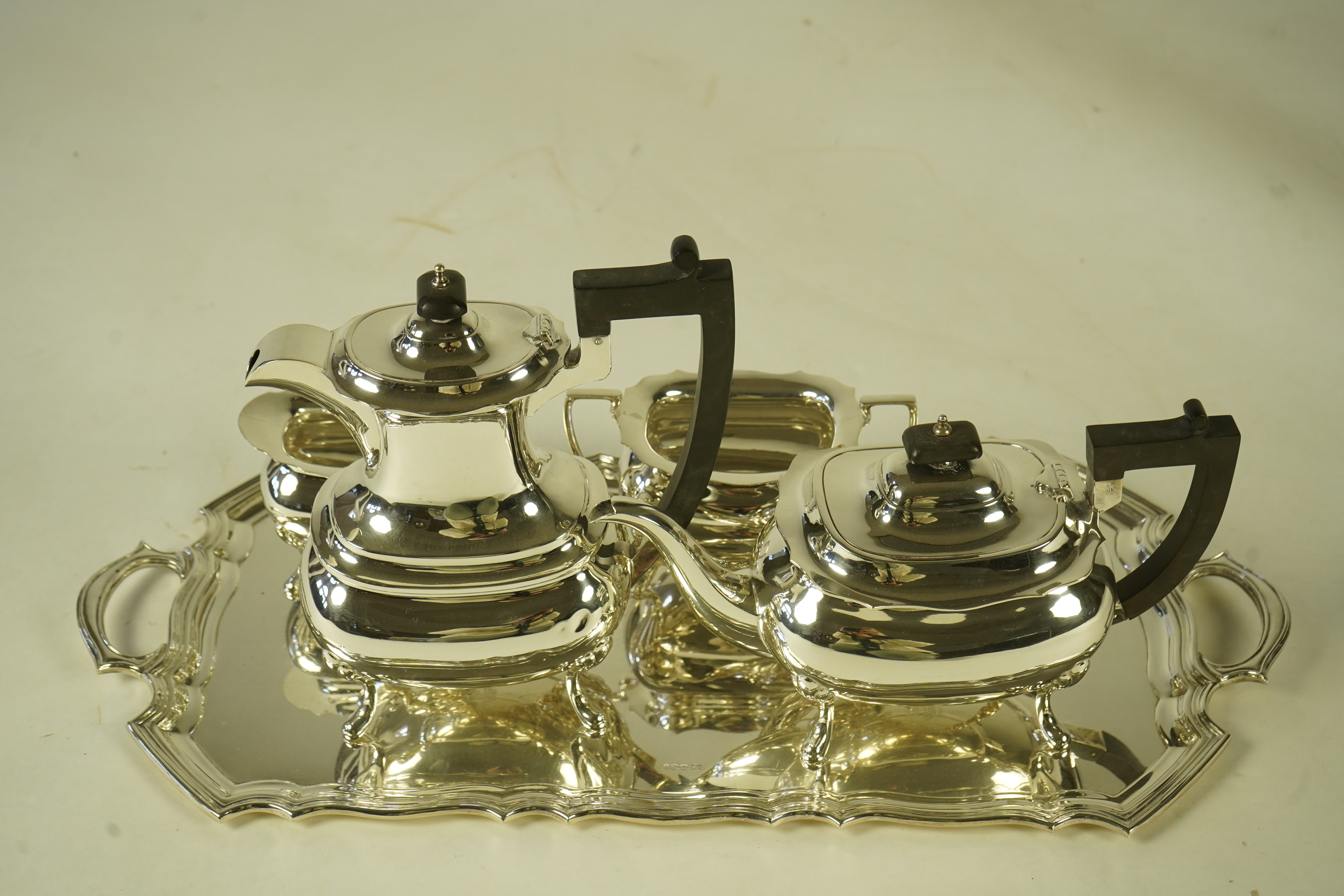 An Elizabeth II silver four piece tea service and two handled tea tray, by Walker & Hall